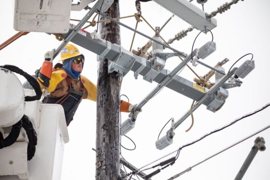 A worker repairs a power line in Austin, Texas.